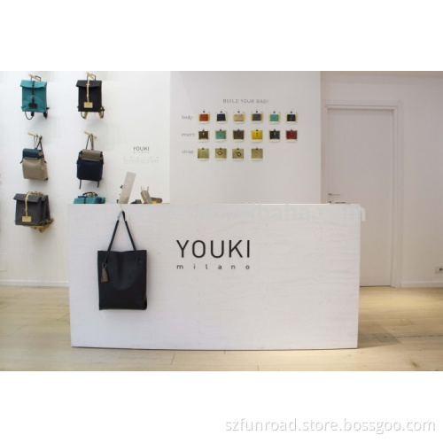 Customized unique cash counter with display shelves for handbag store design